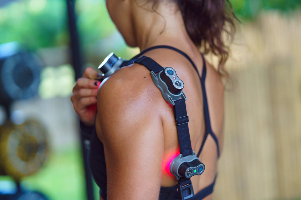 An image of a female's shoulders where light therapy is applied for the purpose of pain reliefe, etc.