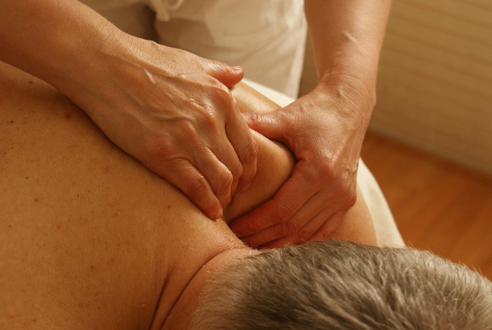 An image of a man having his aching shoulder massaged.
