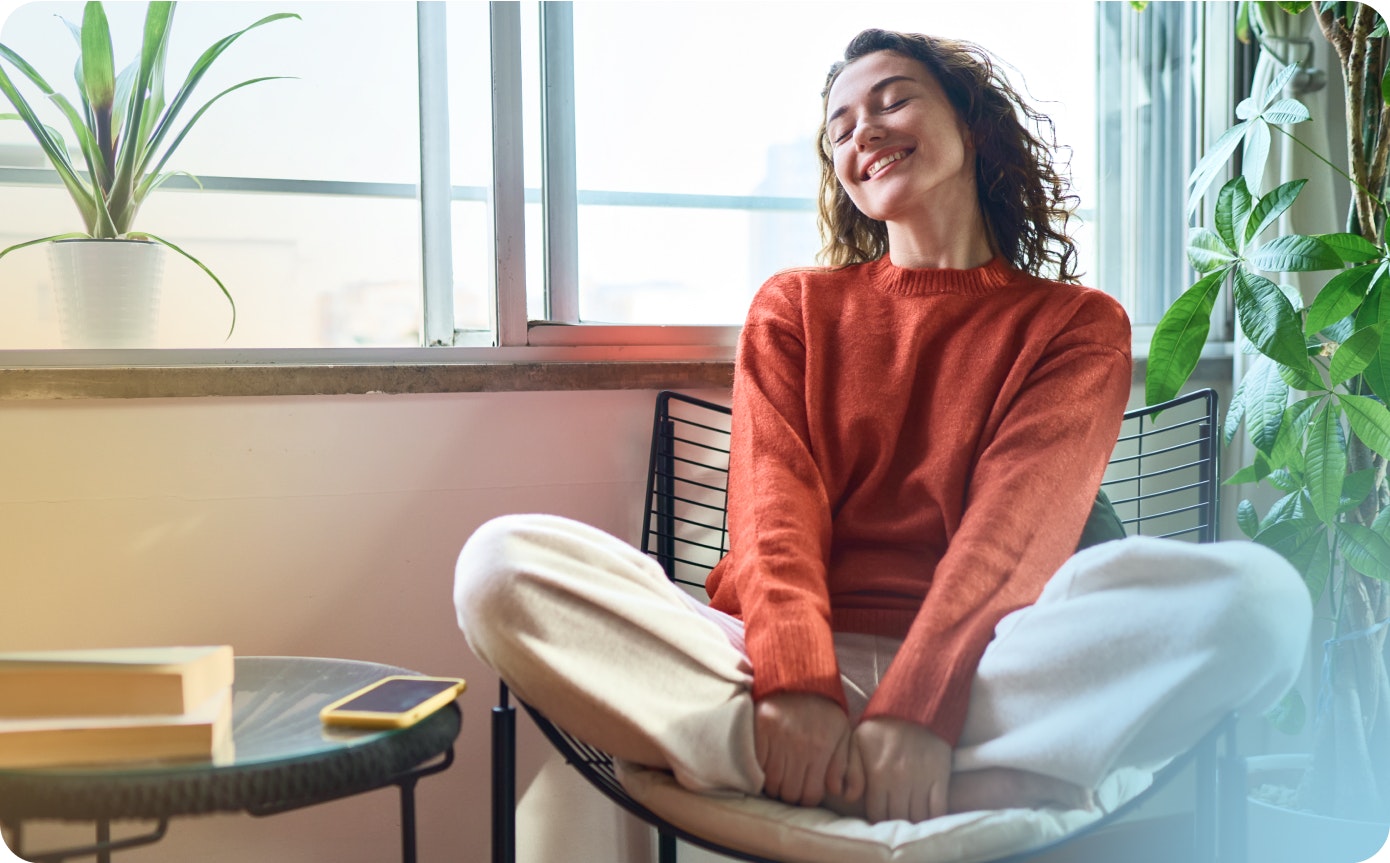 A happy woman in her living room living her life without pain and discomfort.