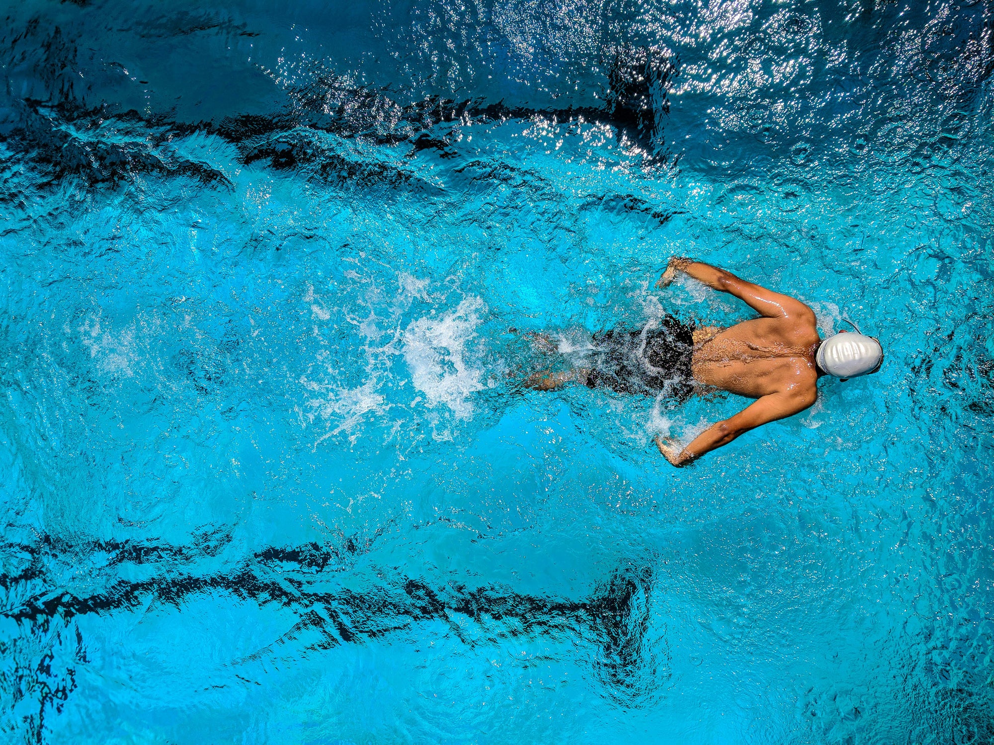 An image of a man swimming in the pool.