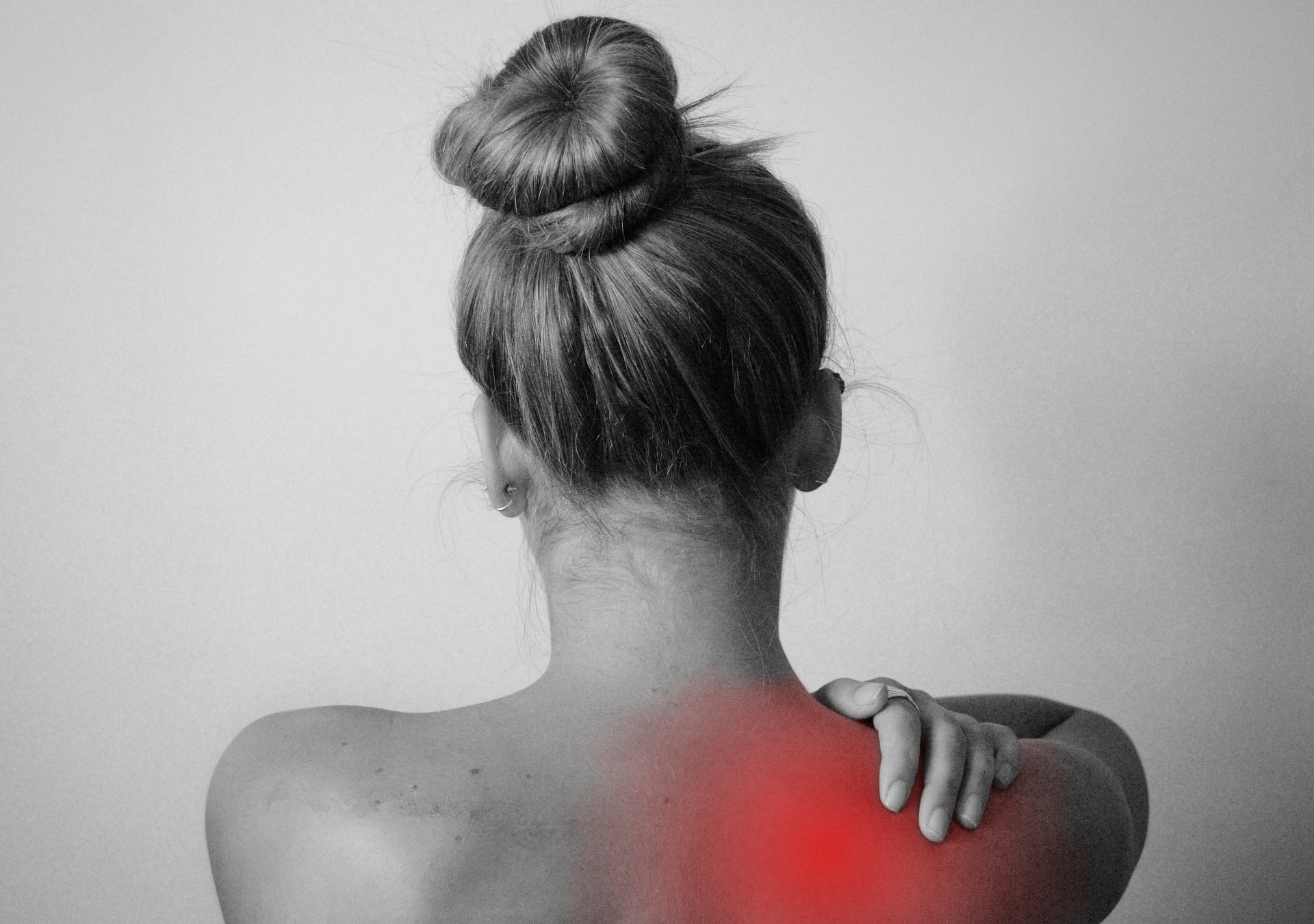 An image of a woman's shoulder with red mark, meaning shoulder pain.