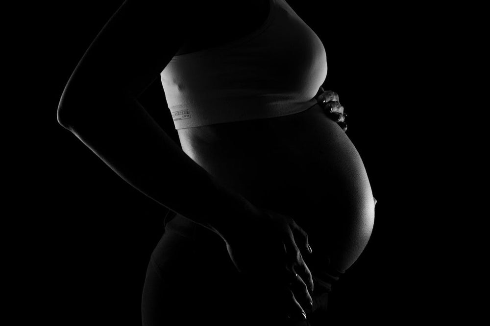 A grayscale image of a pregnant woman.