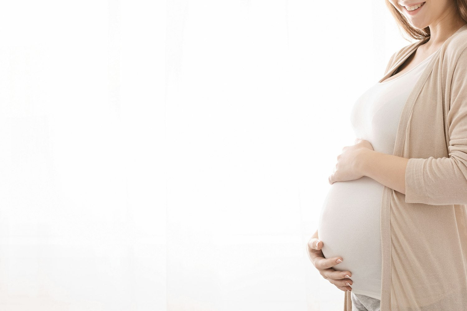 A pregnant woman in a white background.