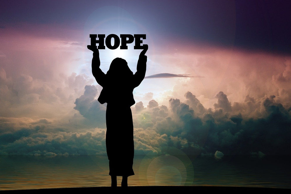 A woman's silhouette, raising a word that says hope. This signifies there's hope to nerve damage with red light therapy.