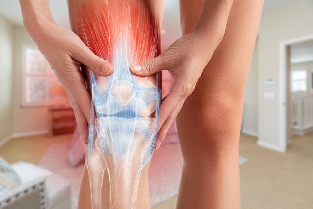 An image of a knee in a bedroom background that indicates arthritis and red light therapy as healing.